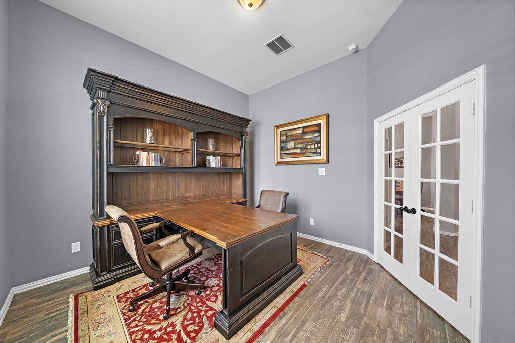 The office also features double french doors and tall ceilings.