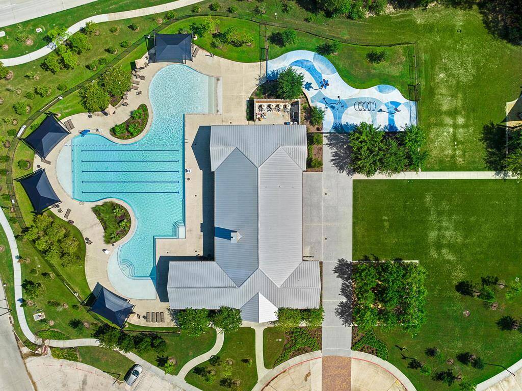 Neighborhood amenity center featuring a club house, gym, splash pad, pool, and park.
