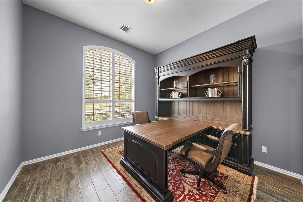 The office is located off of the front entryway featuring shutters.