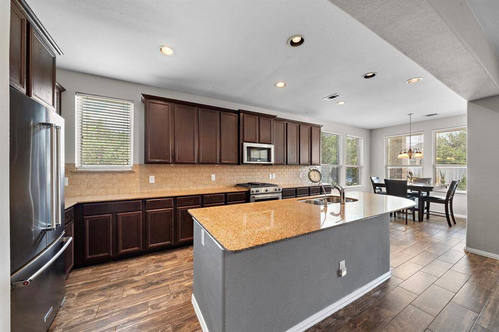 The kitchen features granite countertops and a breakfast bar for extra seating.
