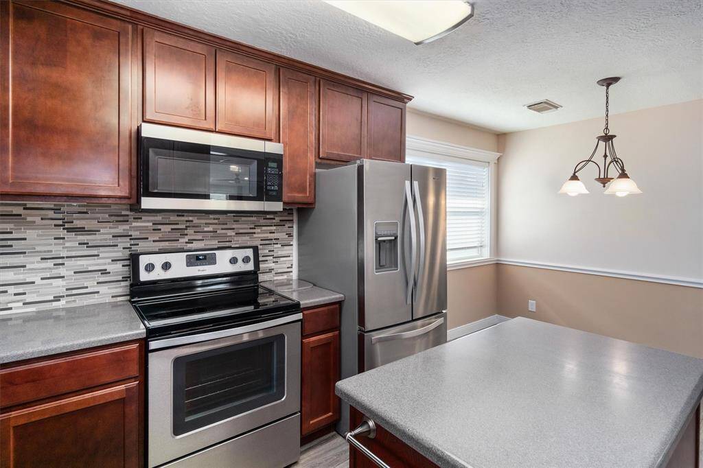 The cabinets are modern and stylish. The kitchen, dining area and living area are open concept which is great for entertaining
