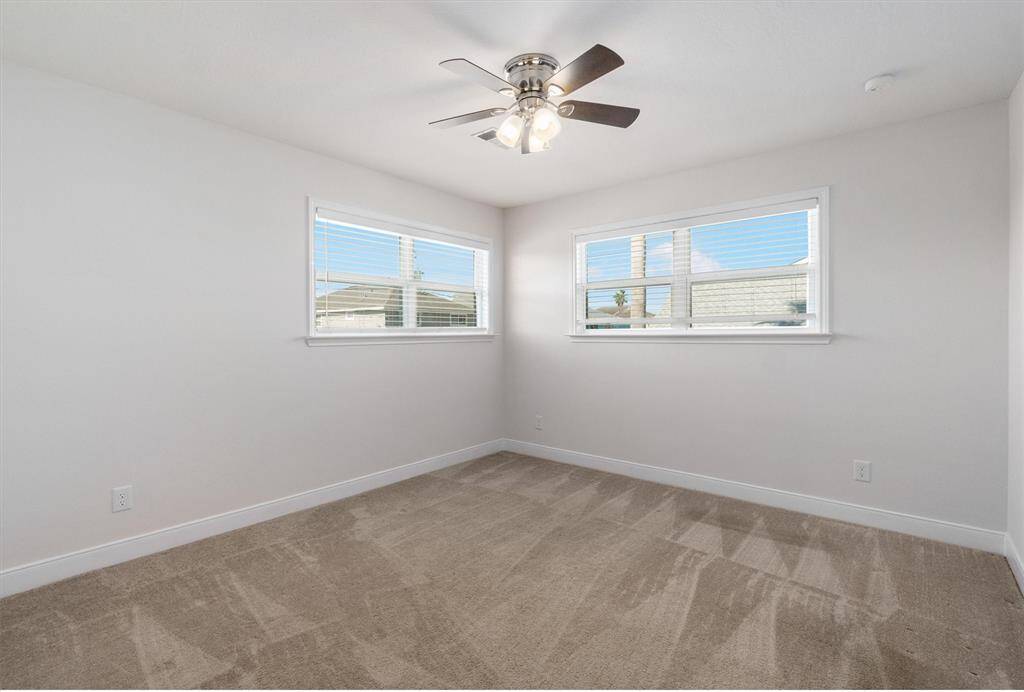The primary bedroom is large with natural lighting