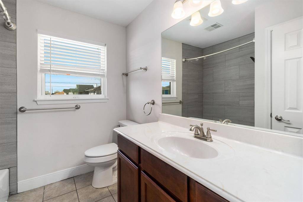 The bathroom was remodeled in 2018 with updated cabinets, fixtures and custom tile