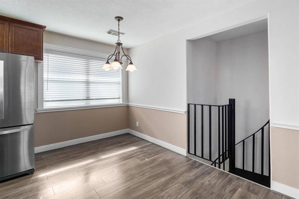 The dining area is roomy enough for a nice sized table. These cute spiral stairs take you downstairs or you can use the door downstairs
