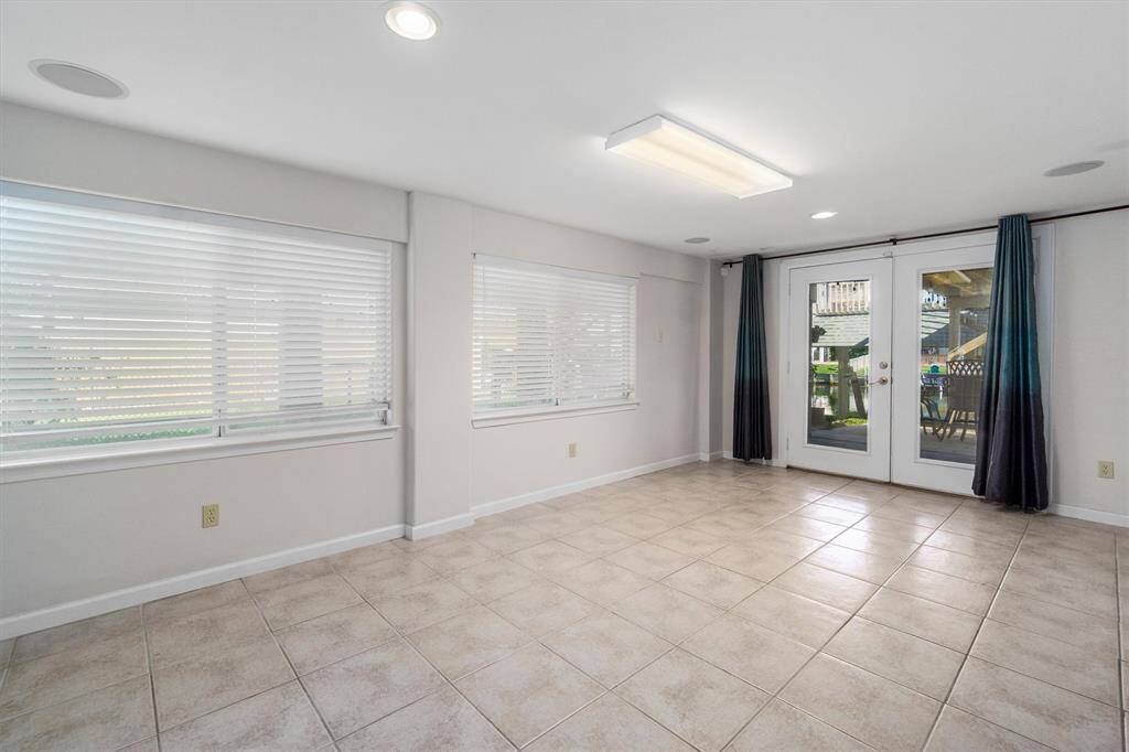 The downstairs area can be another living area, bedroom, bar area, gameroom, or whatever you want. These french doors are the main entrance into the downstairs, and they overlook the water