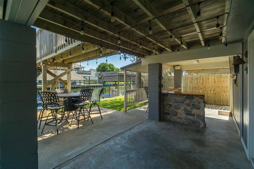 This is right outside of the downstairs french doors. The entertaining area is shady in the afternoons and is plenty of room for outdoor furnishings. Notice the custom stone bar