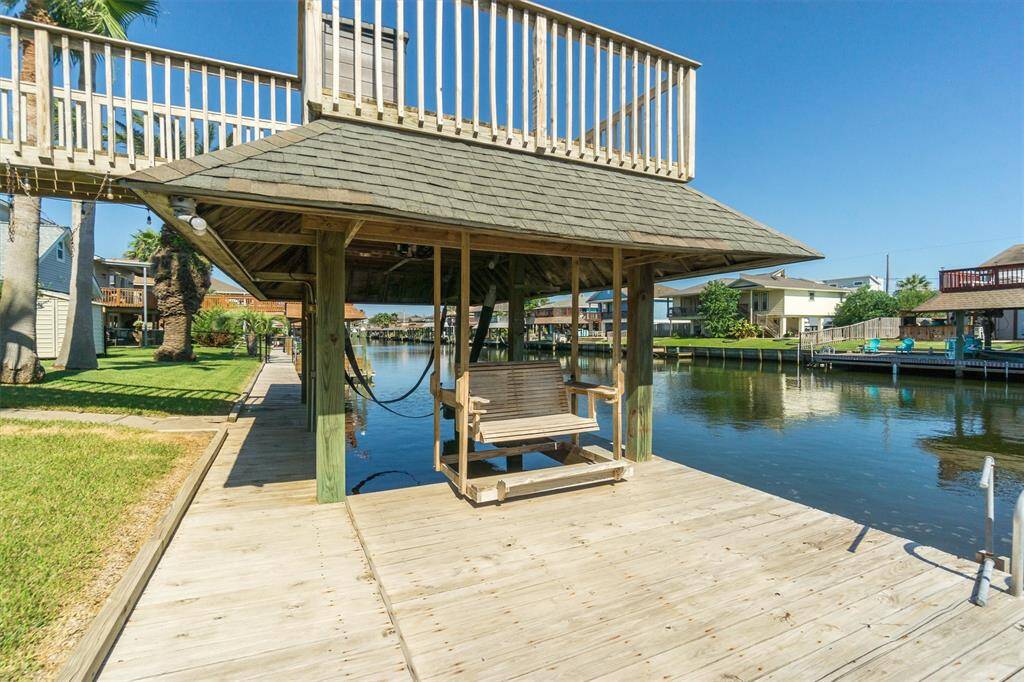 Oversized dock with a ladder for swimming, the upper party deck, and a built in swing