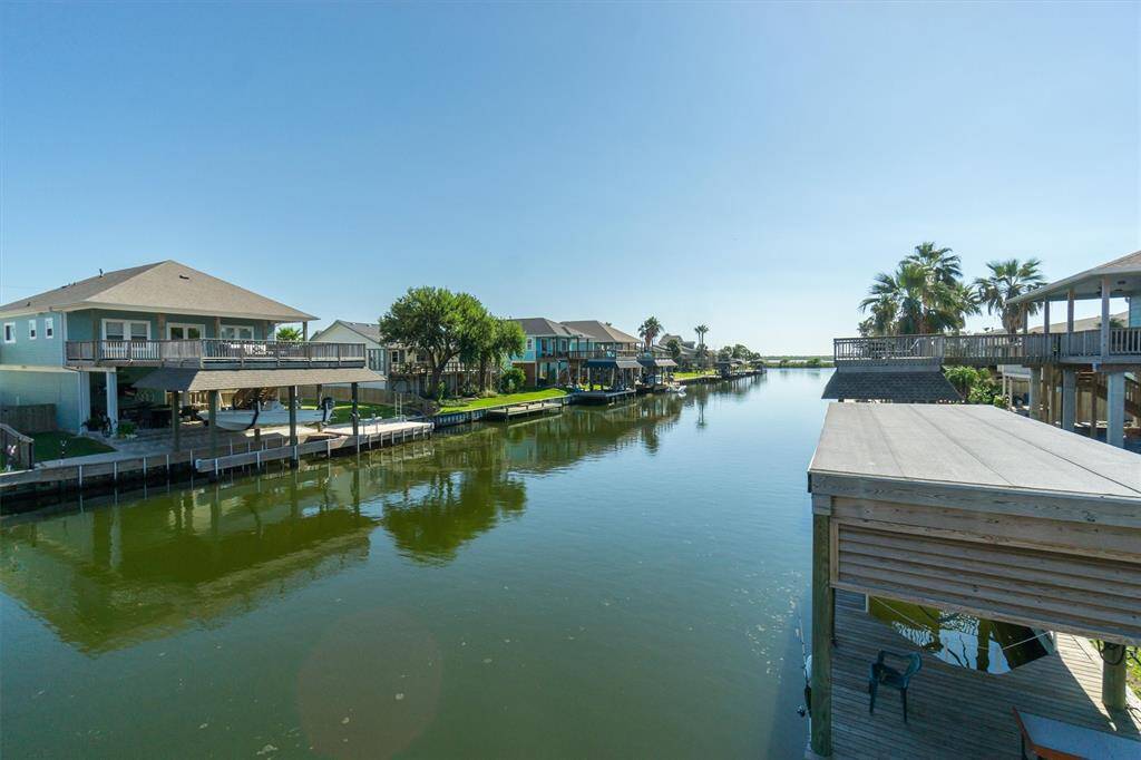 View from the upper party deck towards the lateral canal. You can see how closely the railroad bridge and boating exit are. This home sits very close to the end of the canal which makes for a quicker boating exit