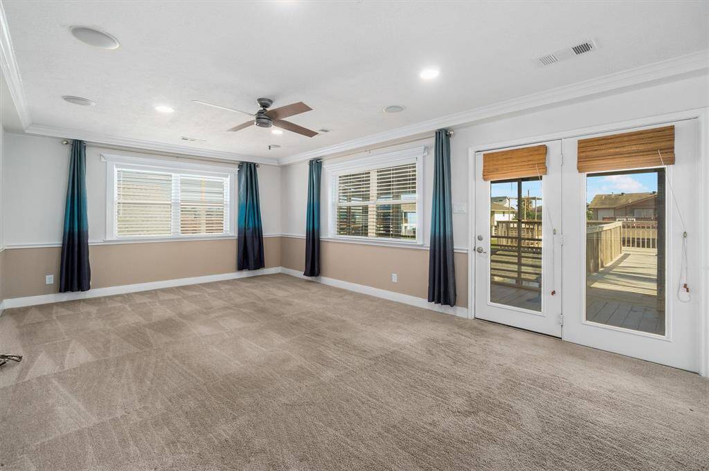 The living area is very large with plenty of windows, natural lighting and crown molding
