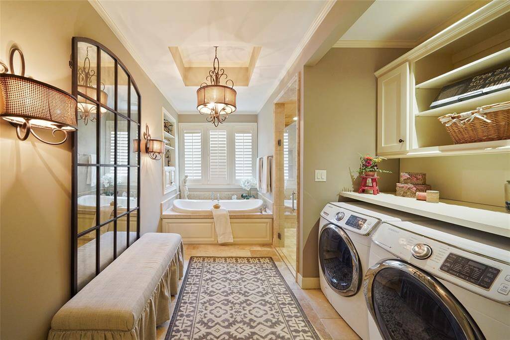Laundry room is conveniently located in the primary bath.