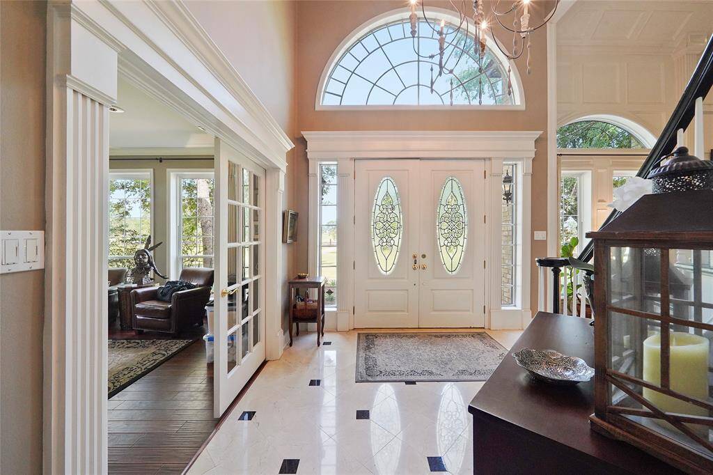 Enter into the beautiful 2 story foyer w/ marble floors & a curved staircase!
