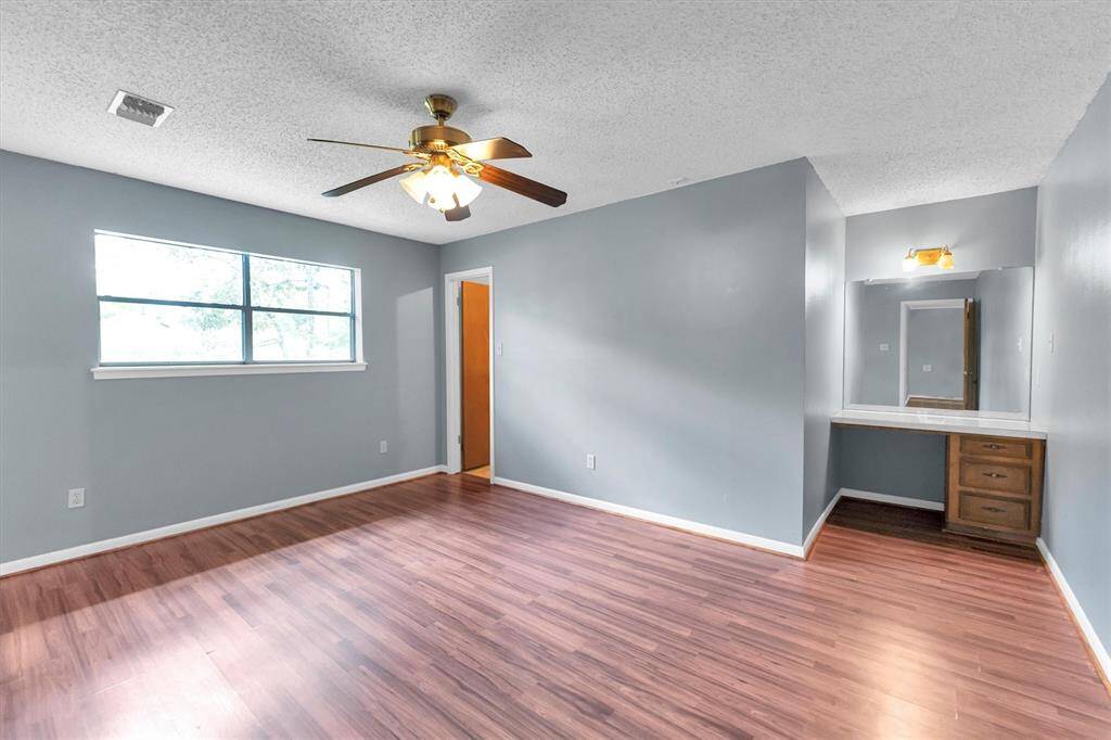 This primary bedroom has a built in home office desk or vanity