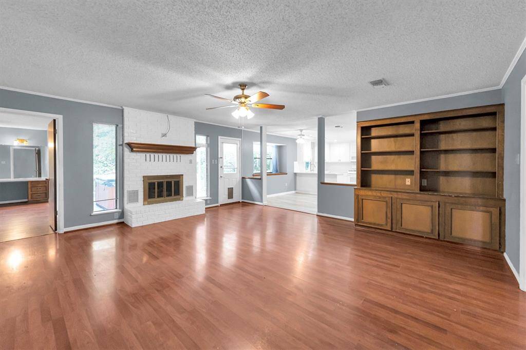 Living room with built in bookshelves and gas log fireplace