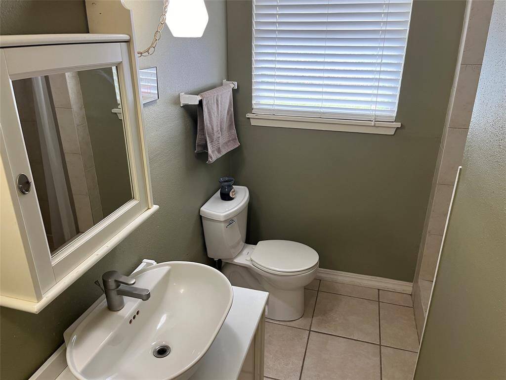 There's a full bath downstairs, across from the stairs. There's a nice tiled shower at the far right corner of this picture.