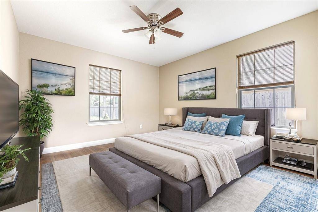 *Virtually Staged*This is a bright and airy bedroom featuring a  ceiling fan. The room has hardwood flooring, two windows with blinds bringing in natural light.