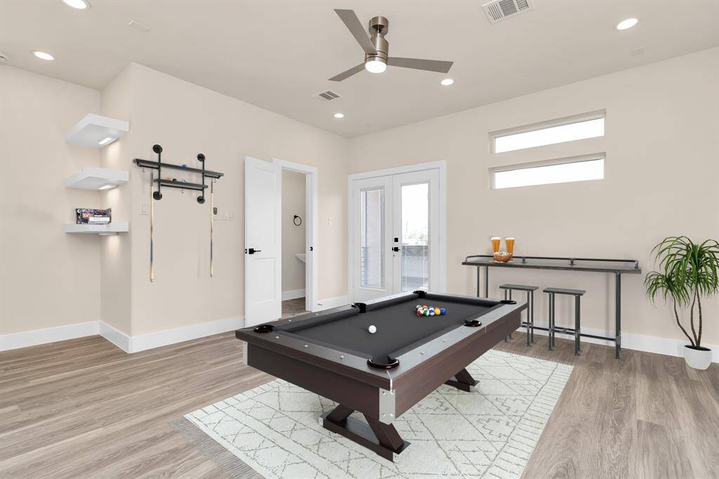 Gameroom / media with floating shelves, ceiling fans and door to the balcony.(Virtual staging)