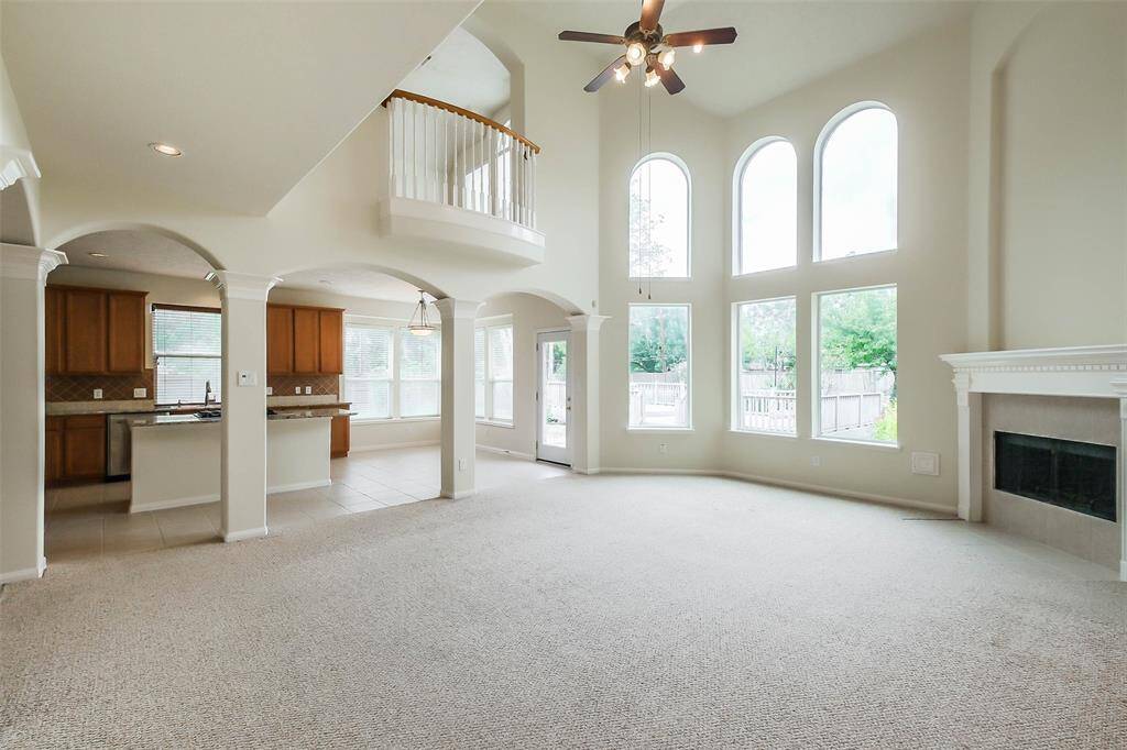 The formal living room seamlessly connects to the kitchen, creating an open, inviting space that emphasizes comfort and easy accessibility.