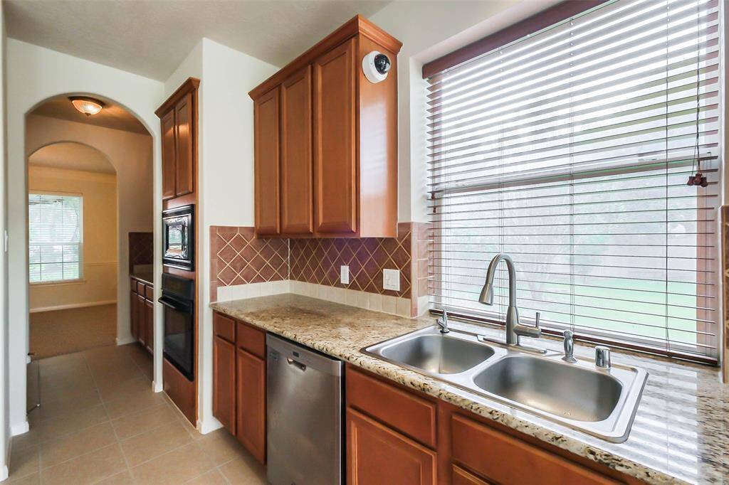 A stylish kitchen sink set in a sleek granite countertop