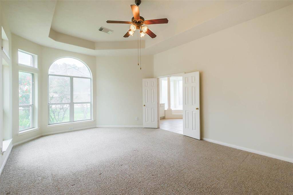 Bright primary bedroom with large glass windows, flooding the space with sunlight. This primary bedroom has a spacious bathroom with luxurious standing shower, tub, and 2 separate sinks. While located on the first floor offers excellent privacy and tranquility.