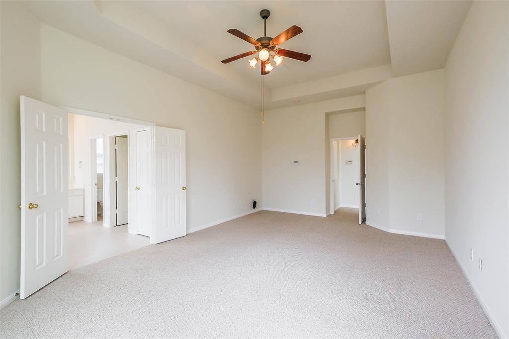 Spacious primary bedroom offers luxury and comfort