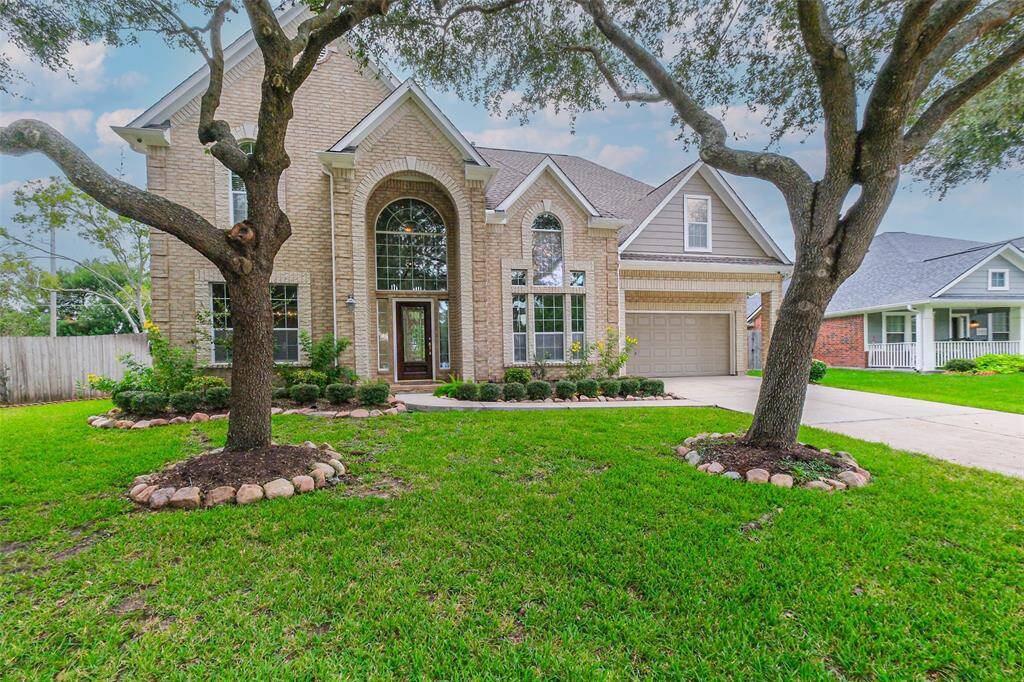 Well maintained landscaping with 2 large oak trees offers a perfect curb appeal