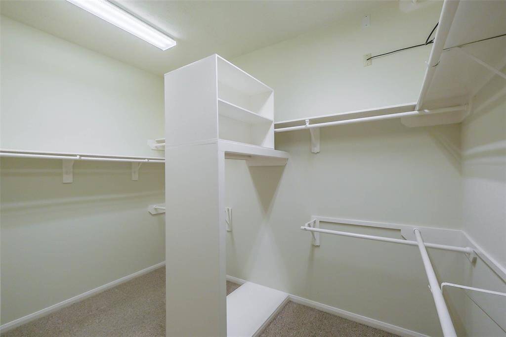 A walk-in closet has plenty of space for personal items of two