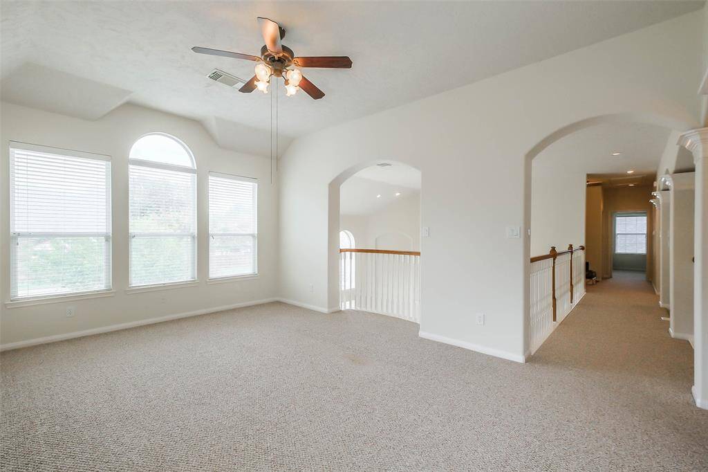 A vibrant game room with large glass windows offers space with sunlight, perfect for entertainment and relaxation