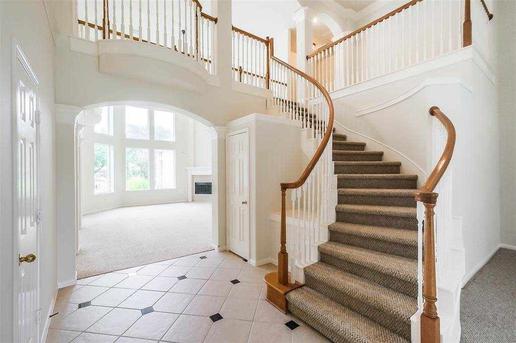 This home features a wide spiral staircase leading to upstairs