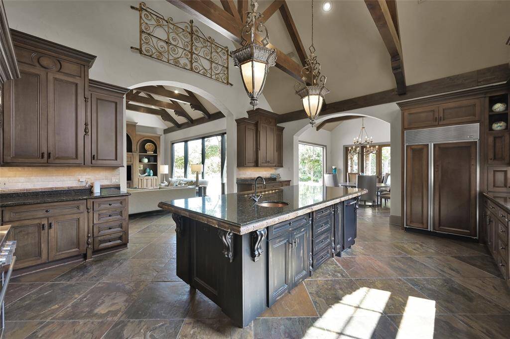 Kitchen with view of family room, breakfast room and backyard.