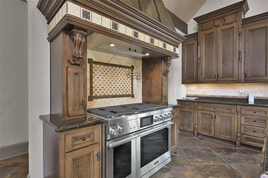 New (2024) Dacor 48" gas range with double ovens. Pot filler above range.