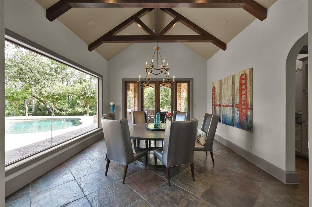 Breakfast room with expansive frameless window and French doors for direct access to the outdoor covered patio.