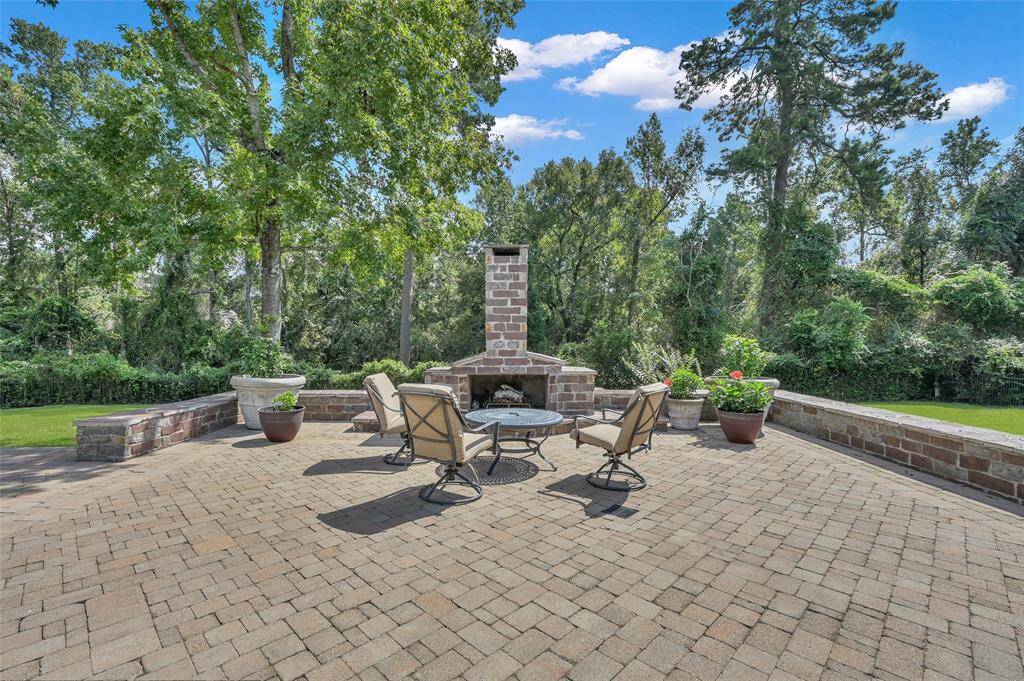 Outdoor gas fireplace with cozy seating area.