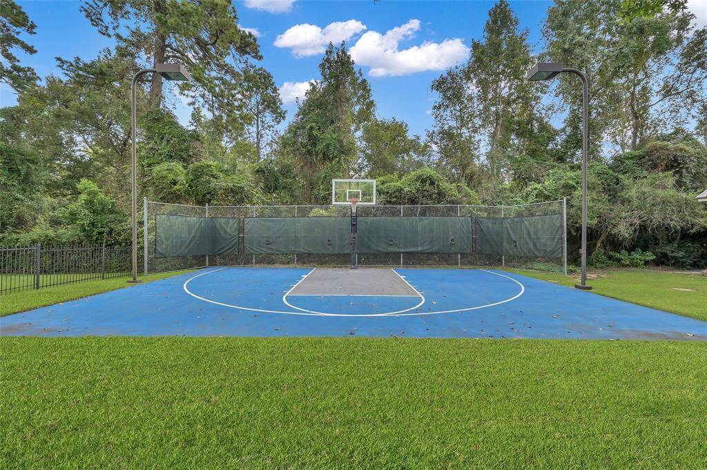 Lighted sport court with basketball goal.