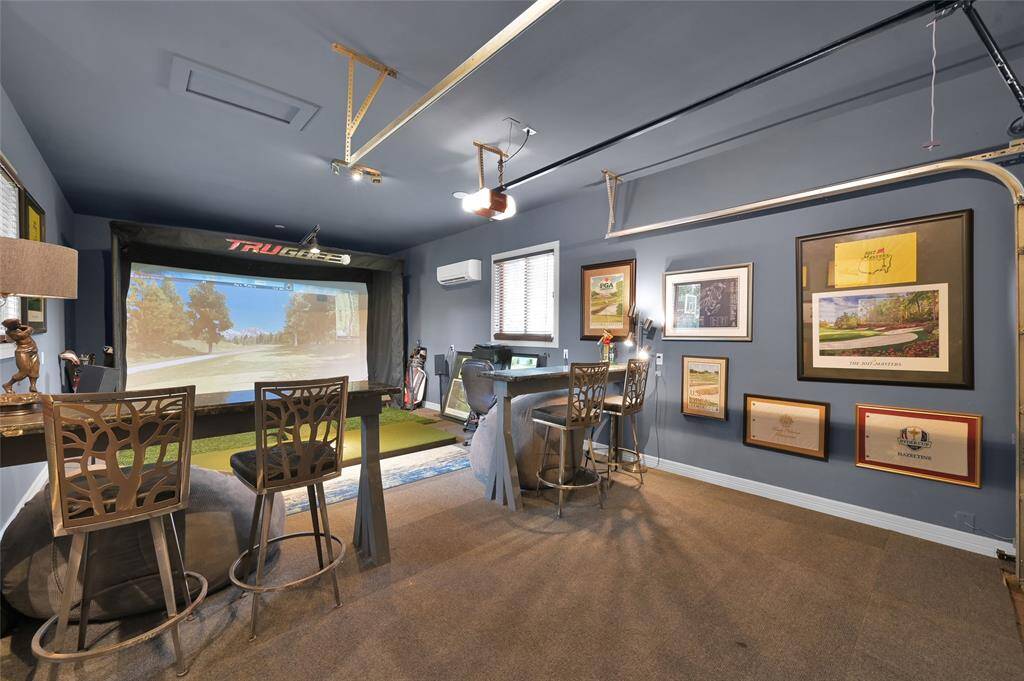Workshop equipped with a mini-split A/C, currently set up as a golf simulator.