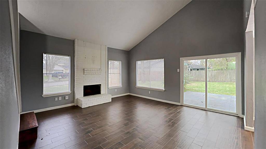 Inviting open-plan living space with an elegant fireplace and abundant natural light.