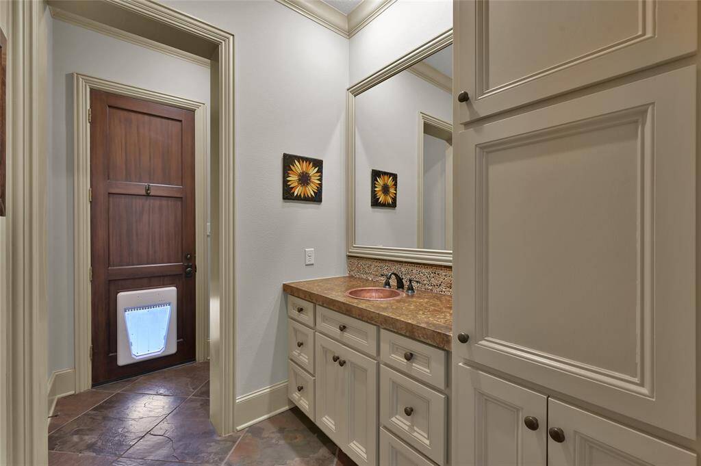 Half bathroom with direct access to covered patio.