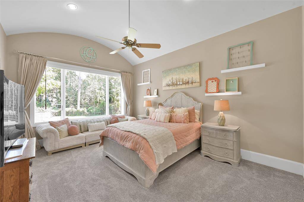 Bedroom 3 - The bedroom has recent carpet, a barrel vaulted ceiling and a large window.