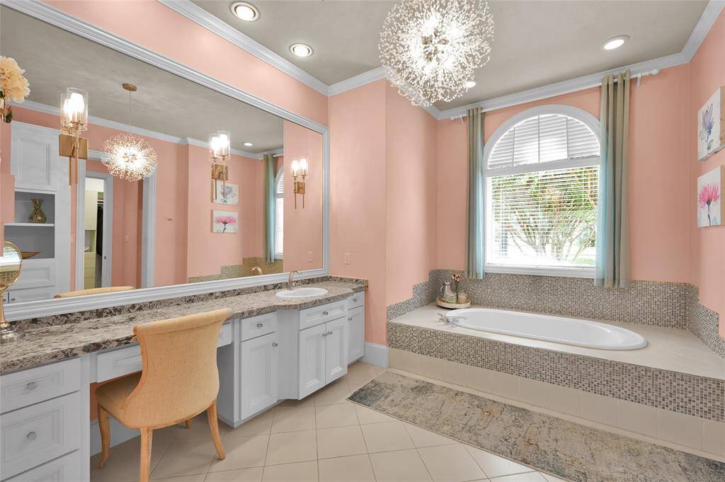 Bathroom 3 is en-suite and spacious, featuring a generous granite countertop vanity, a separate linen closet, a private shower, a water closet, and a walk-in closet with custom built-ins.