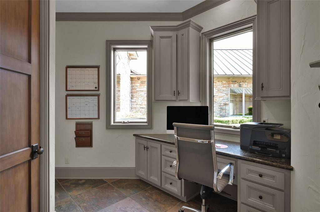Convenient built-in workstation located near kitchen and mudroom, overlooking the courtyard.