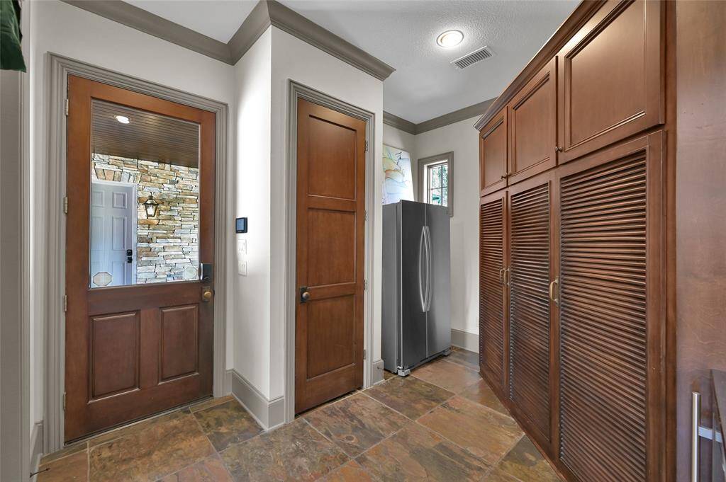 Mudroom off the porte-cochere, featuring additional storage and space for a full-size refrigerator. Not in photo is another large closet - so much storage!