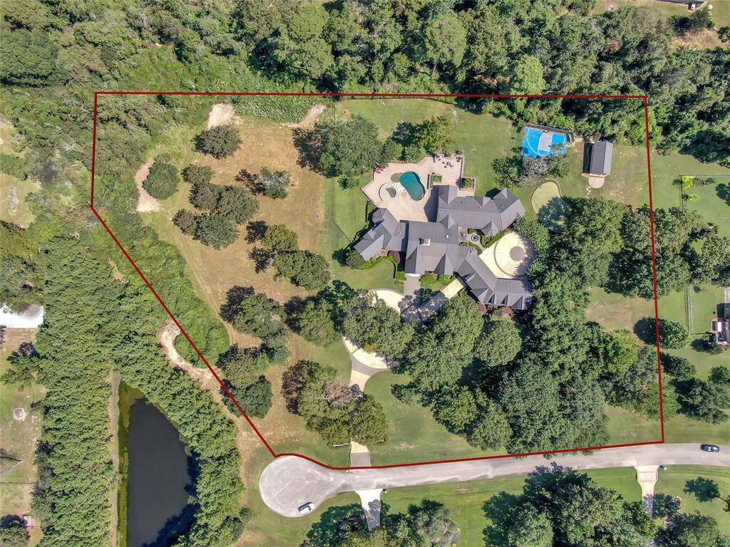 The red lines outline the estimated 4.8 acres of the lot. Please refer to the survey for a more detailed view of the property boundaries.