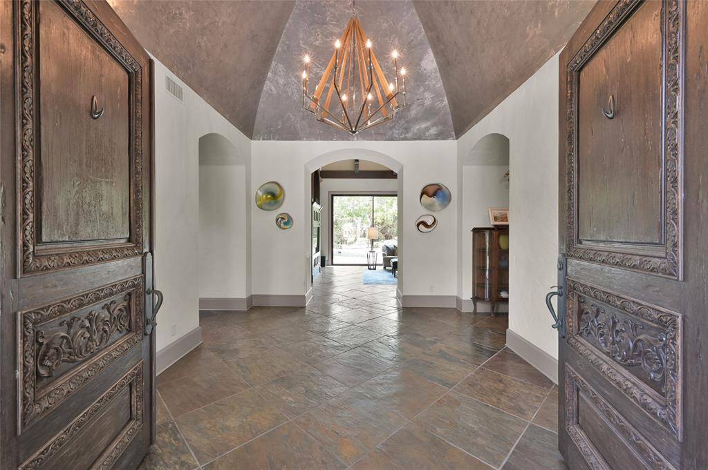 Elegant foyer showcasing stylish designer paint finishes and exquisite lighting.