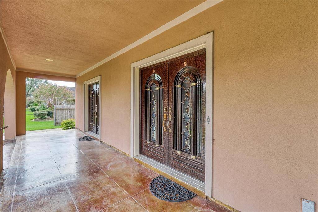 The massive front porch has three sets of double doors imported from Mexico to welcome your guests.