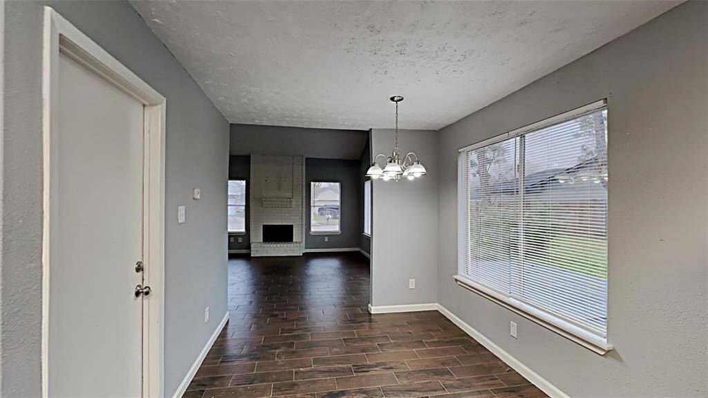 Seamlessly transition from the cozy dining nook to the spacious living area, bathed in natural light.