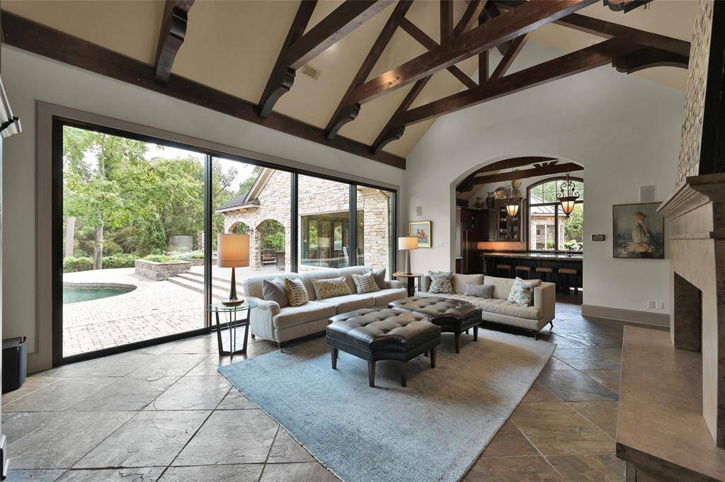 Family room with pool and covered patio views. Gourmet kitchen is connected to the family room.