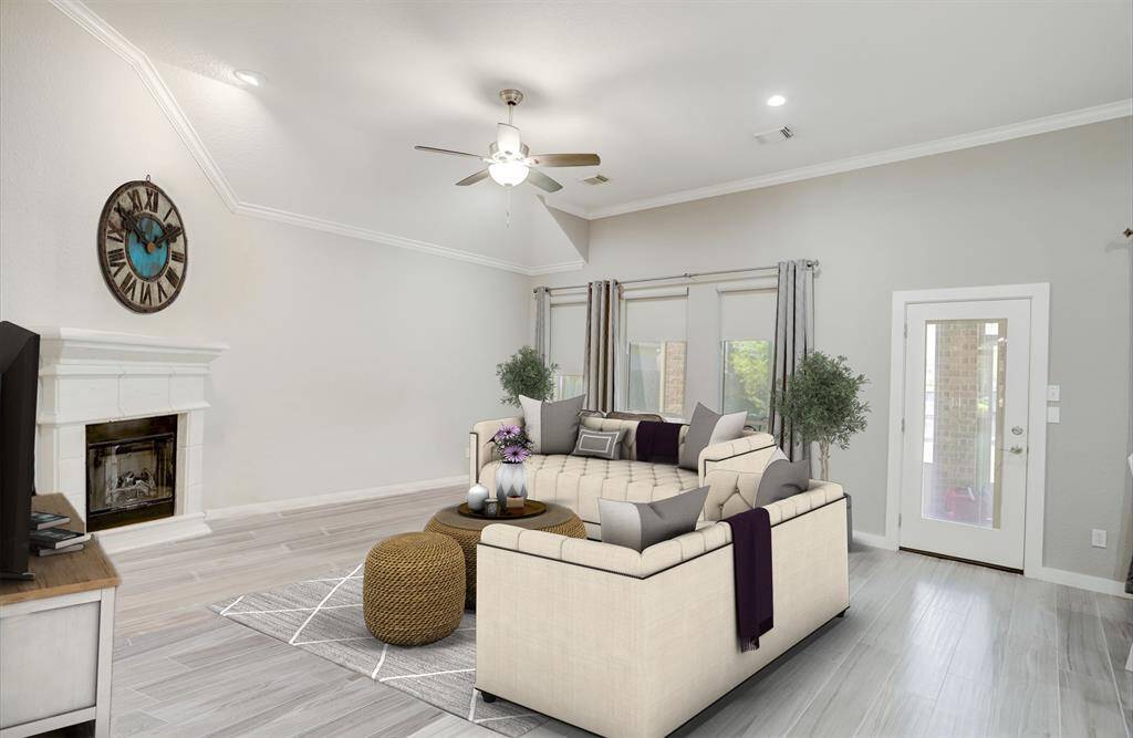 THIS FAMILY ROOM FEATURES A HIGH CEILING, GORGEOUS WOOD FLOORS, A FIREPLACE AND WALL OF WINDOWS THAT ALLOW TONS OF NATURAL LIGHT. ***This room has been virtually staged.