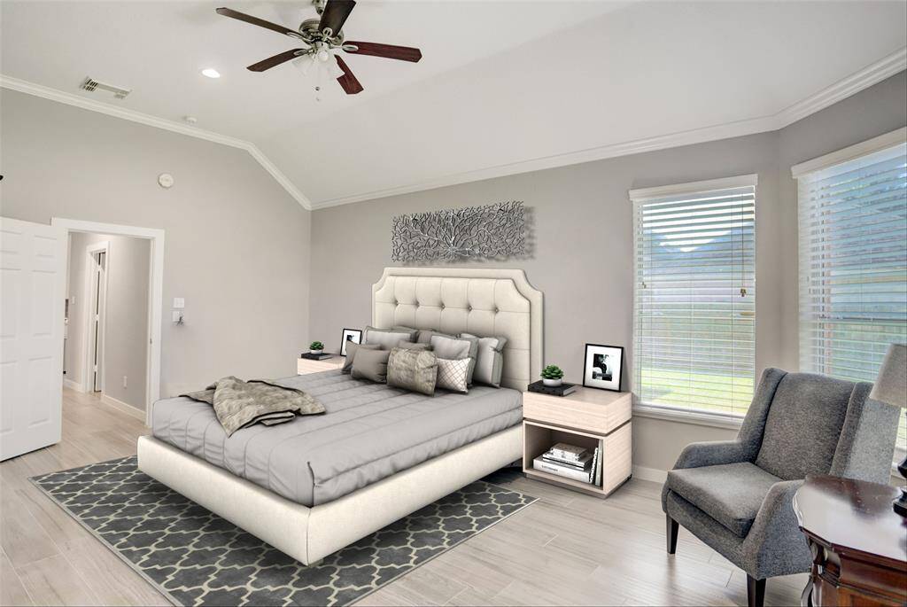 THE FIRST-FLOOR MASTER BEDROOM IS SPACIOUS, WITH A SEATING AREA THAT OVERLOOKS THE BEAUTIFUL BACKYARD. ***This photo has been virtually staged.