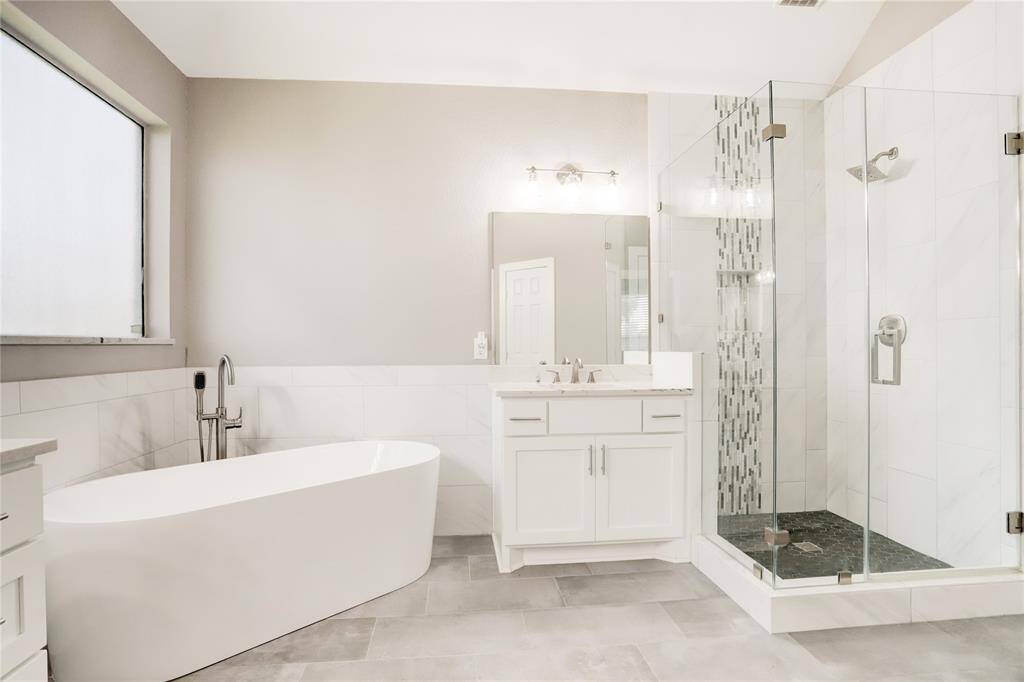 LARGE JETTED TUB AND SEPARATE SHOWER WILL HELP YOU RELAX AT THE END OF THE DAY.