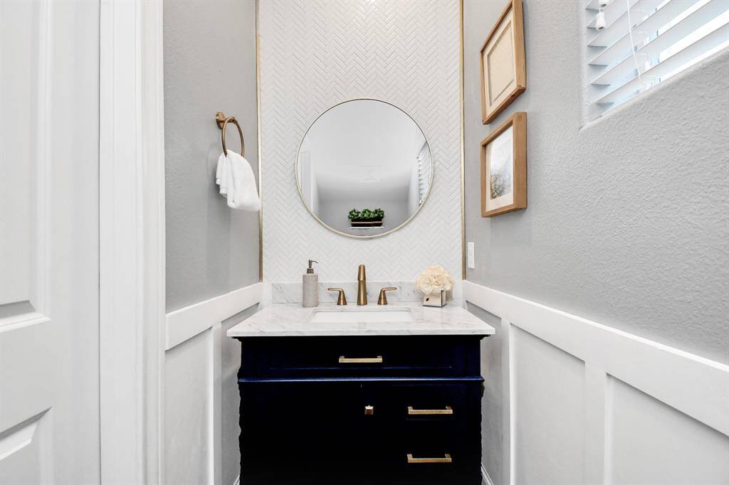 Completely remodeled and upgraded powder bathroom! This elegant space is designed to impress your guests with its modern finishes!
