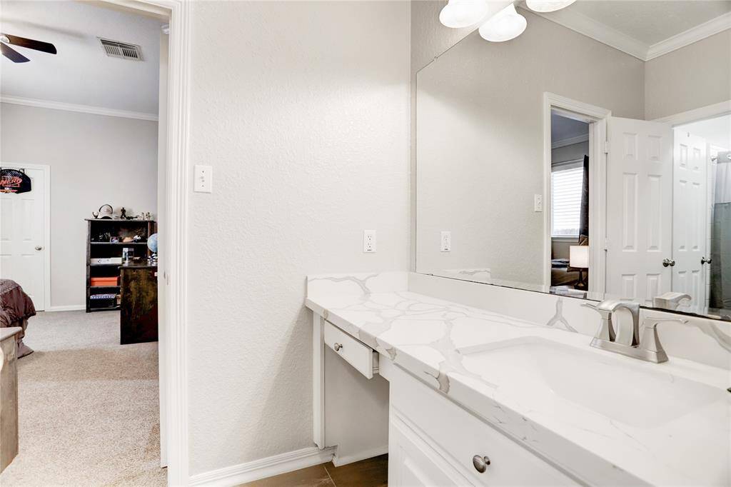 SECONDARY BATHROOM FEATURES AN EXTENDED COUNTER WITH A SINK AND VANITY. BATHROOM IS CONVENIENTLY LOCATED JUST RIGHT OFF THE GAME ROOM.